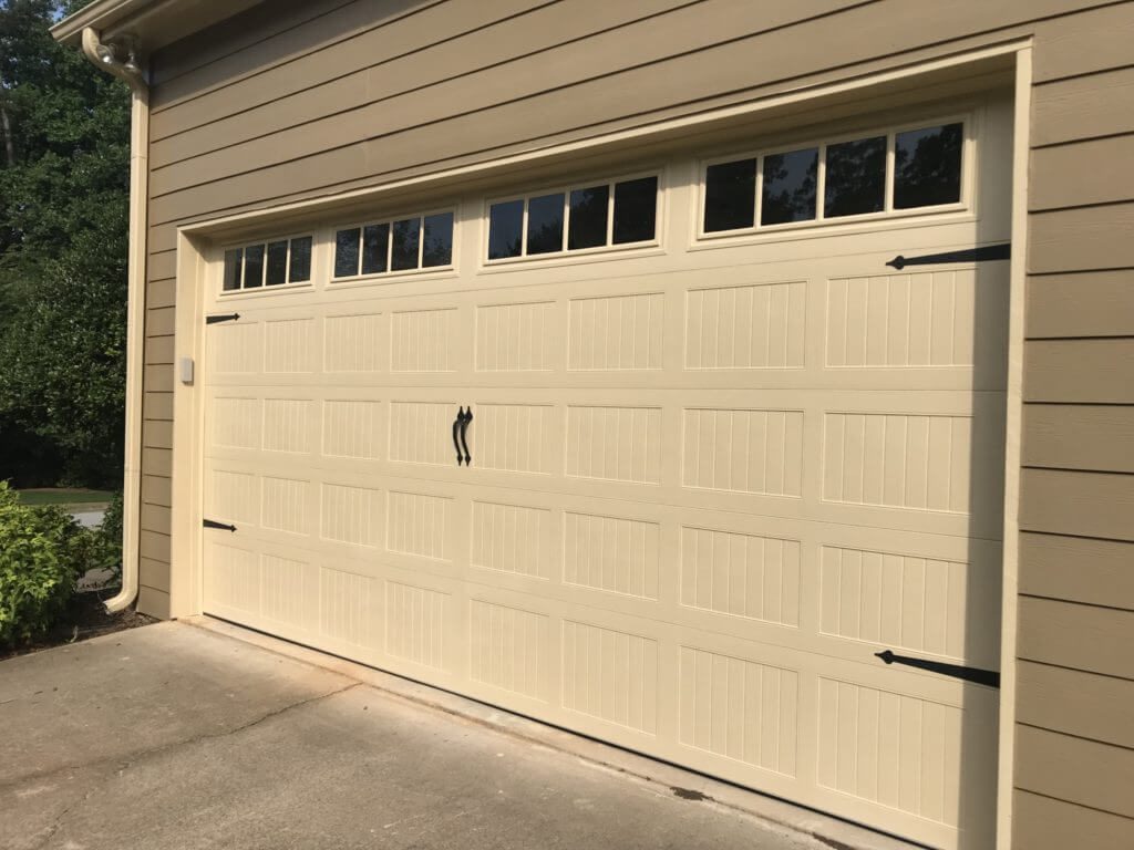 Desert tan carriage garage door with arched windows