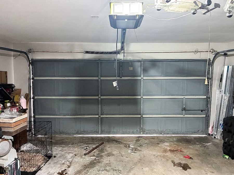 Old worn garage door interior with aging hardware
