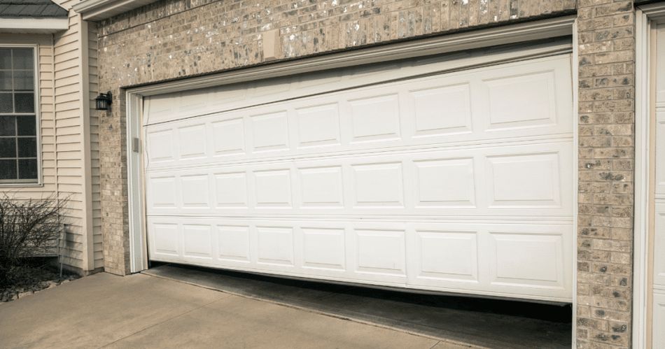 Garage door hanging crooked and off-track on one side