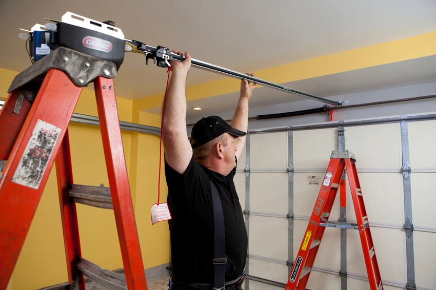 Technician installing a Genie garage door opener rail