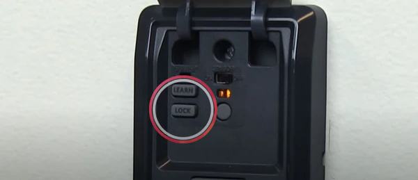 Garage door wall control panel with Learn and Lock buttons