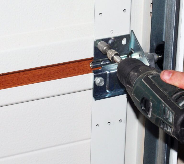 Tightening a garage door hinge bracket with a drill