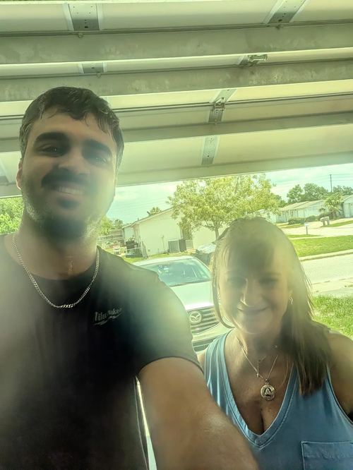 Elevate Garage Doors technician with happy customer Mary Viruet