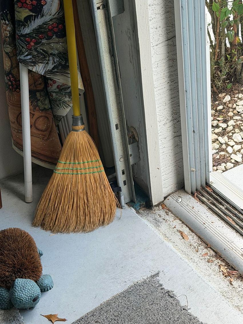 Broom leaning in front of a garage door safety sensor