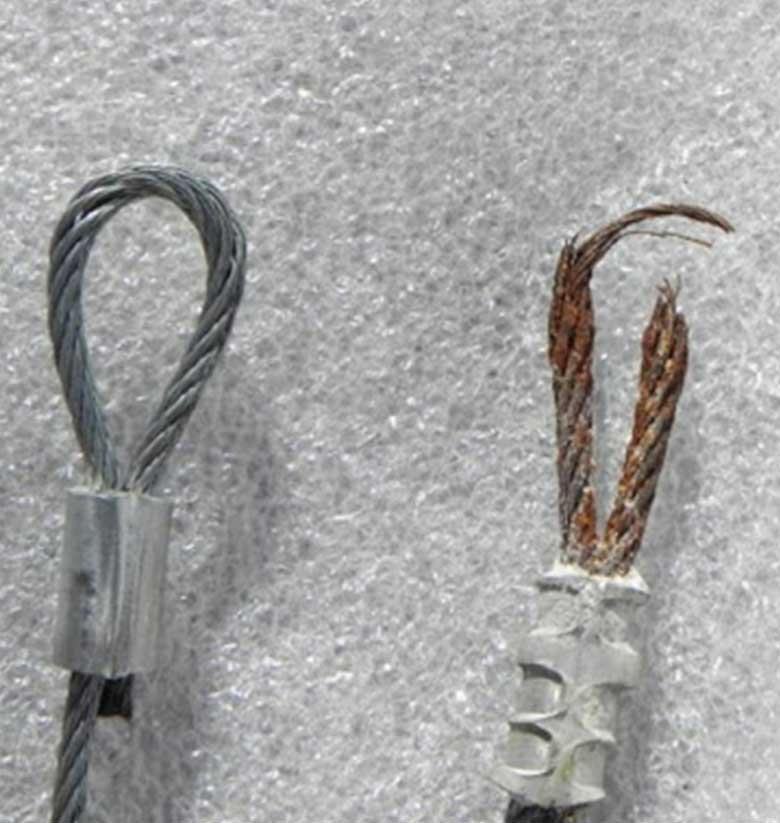 Healthy garage door cable next to a badly frayed one