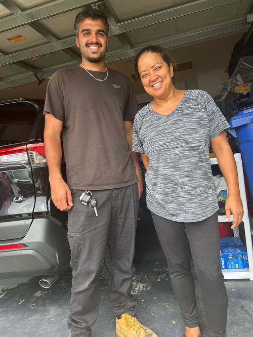 Elevate Garage Doors technician with happy customer Aida Gonzalez