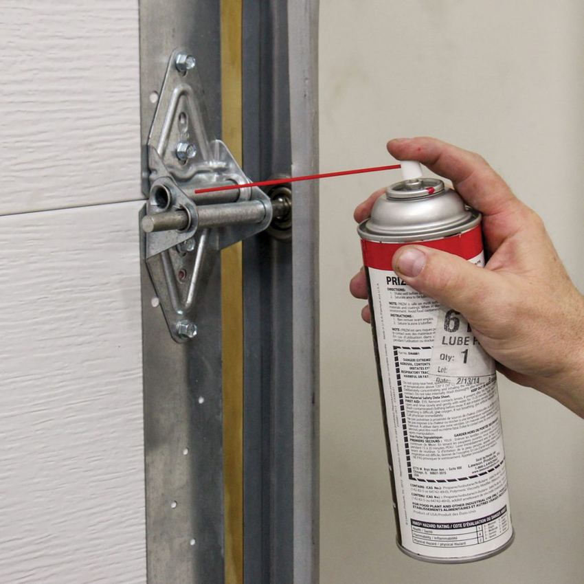 Applying lubricant to a garage door hinge bracket