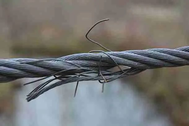 Frayed garage door cable with broken strands